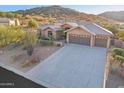 Beautiful home featuring a spacious driveway and desert landscaping at 11255 S San Adrian Ln, Goodyear, AZ 85338