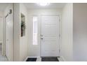 Bright entryway featuring a white front door, tile flooring, and natural light at 1335 E June St # 107, Mesa, AZ 85203