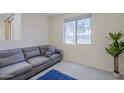 Inviting living room with a comfortable sofa, a large window and modern decor at 1335 E June St # 107, Mesa, AZ 85203