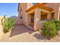 Side view of the house showing the low-maintenance landscaping and covered porch at 1556 E Gabrilla Dr, Casa Grande, AZ 85122