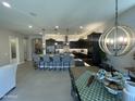 Modern kitchen with stainless steel appliances, pendant lighting, and a large island with barstool seating at 15801 W Cielo Grande Ave, Surprise, AZ 85387