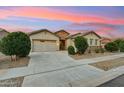 Beautiful single-story home with a stone-accented facade, desert landscaping, and a well-maintained front yard in a quiet neighborhood at 16852 W Creedance Blvd, Surprise, AZ 85387