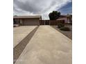 Large driveway leading to the attached garage and fenced in backyard at 1804 W Kristal Way, Phoenix, AZ 85027