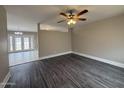 Open-concept living room featuring modern flooring, neutral paint, and a ceiling fan at 1804 W Kristal Way, Phoenix, AZ 85027