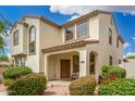 Inviting two-story home featuring a cozy covered porch and well-maintained desert landscaping at 1912 S Colt Dr, Gilbert, AZ 85295