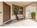 Cozy front porch with comfortable bench seating, offering a welcoming entrance to the home at 1912 S Colt Dr, Gilbert, AZ 85295