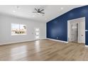 Bright and airy living room featuring new floors, a modern door, and an accent wall at 2122 W Virginia Ave, Phoenix, AZ 85009