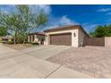 View of a single story home's exterior featuring manicured landscaping and a two car garage at 27007 N 20Th Ln, Phoenix, AZ 85085