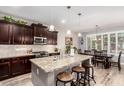Spacious kitchen featuring dark wood cabinetry, granite countertops, and stainless steel appliances at 27007 N 20Th Ln, Phoenix, AZ 85085
