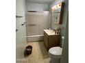 Bathroom featuring a shower-tub combo with sliding doors, vanity with storage, and a standard toilet at 2937 W Marshall Ave, Phoenix, AZ 85017