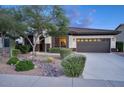 Inviting home exterior showcasing desert landscaping and a dark brown two-car garage at 2991 E Fandango Dr, Gilbert, AZ 85298