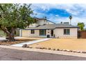 Charming two-story home featuring tidy desert landscaping, a balcony, and white brick exterior at 3038 E Avalon Dr, Phoenix, AZ 85016