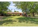 Charming home with a spacious front yard, mature trees, and an inviting patio area for relaxing at 31 W Marlette Ave, Phoenix, AZ 85013
