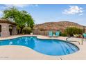 Community pool features desert landscaping, mountain views and lounge seating at 3236 E Chandler Blvd # 2028, Phoenix, AZ 85048