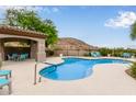 Community pool featuring lounge seating, covered ramada, and desert landscaping at 3236 E Chandler Blvd # 2028, Phoenix, AZ 85048