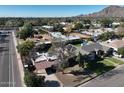 Scenic aerial view of a residential neighborhood with mountain views and mature landscaping at 3404 N Kachina Ln, Scottsdale, AZ 85251