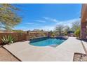 Stunning private pool surrounded by lush desert landscaping with a built-in barbecue area, perfect for outdoor entertaining at 35195 N 98Th St # 85, Scottsdale, AZ 85262
