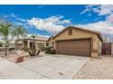 A view of the home showcasing its well-maintained yard and desert landscape with rock and gravel at 3703 S 73Rd Dr, Phoenix, AZ 85043