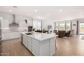 Bright, open-concept living space with a modern kitchen island, stainless steel appliances, and a cozy seating area at 3856 E Shannon St, Gilbert, AZ 85295