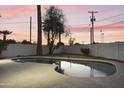 Backyard with a unique shaped pool ready for warm days and good times at 4410 N 20Th Ave, Phoenix, AZ 85015