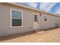 This property features a clean, bright exterior with a classic white door and well-placed windows for ample natural light at 46 S 96Th St, Mesa, AZ 85208