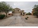 Attractive two-story home featuring a spacious driveway and well-maintained desert landscaping at 4804 S 25Th Dr, Phoenix, AZ 85041