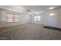 Bright living room featuring neutral carpet, modern lighting and plenty of space at 4804 S 25Th Dr, Phoenix, AZ 85041
