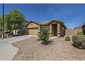 Inviting single-story home with a two-car garage and desert-friendly front yard at 5096 S 245Th Dr, Buckeye, AZ 85326