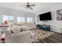 Spacious living room featuring large windows, a cozy sectional sofa, and a decorative area rug at 5321 N 196Th Ave, Litchfield Park, AZ 85340