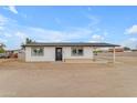 Inviting single-level home featuring a neatly painted white exterior, black-trimmed windows and a convenient side carport at 546 N 96Th Pl, Mesa, AZ 85207