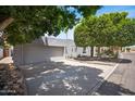 Spacious garage with a wide driveway offering ample parking space, and mature trees surrounding the property at 6333 N Scottsdale Rd # 5, Scottsdale, AZ 85250
