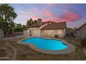 Backyard featuring a sparkling swimming pool and a well-manicured lawn, perfect for outdoor enjoyment at 845 N Oak Ct, Chandler, AZ 85226