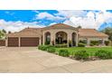 Charming home featuring a three-car garage and lush landscaping, enhancing its curb appeal at 8603 E Aster Dr, Scottsdale, AZ 85260