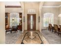 Inviting foyer with marble floors, a decorative front door, and views into the living spaces at 8603 E Aster Dr, Scottsdale, AZ 85260