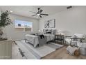Cozy bedroom with a ceiling fan, natural light, stylish decor, and wood-look floors at 10612 N 48Th Ave, Glendale, AZ 85304