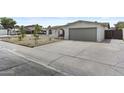 Inviting single-story home with desert landscaping, a two-car garage, and spacious driveway at 10612 N 48Th Ave, Glendale, AZ 85304