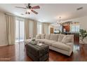 Bright living room with hardwood floors, neutral decor, and sliding glass doors to the outside at 1086 S Nancy Ln, Gilbert, AZ 85296