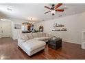 Comfortable living room with hardwood floors, a ceiling fan, and a large sectional sofa at 1086 S Nancy Ln, Gilbert, AZ 85296