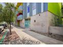 Street-level view of the building's exterior, featuring modern design and colorful accents at 1111 W University Dr # 3016, Tempe, AZ 85281