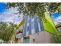 Modern exterior view showcasing the building's unique architecture and vibrant colors against a blue sky at 1111 W University Dr # 3016, Tempe, AZ 85281