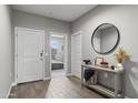 Bright foyer with wood-look tile flooring, neutral walls, and stylish decor at 12105 W Wier Ave, Avondale, AZ 85323