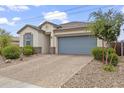 Inviting exterior of a single-Gathering home with a stone driveway and desert landscaping at 12105 W Wier Ave, Avondale, AZ 85323