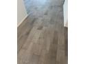Stylish gray tile flooring with a wood-look pattern, adding a touch of modern elegance to the home's interior at 1300 W Bealey Ave, Coolidge, AZ 85128