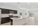 Spacious kitchen with stainless steel appliances, dark wood cabinets, and a marble island at 1337 W Hess Ave, Coolidge, AZ 85128