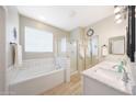 Bright bathroom with double sinks, soaking tub, walk-in shower, and modern fixtures at 16039 W Pima St, Goodyear, AZ 85338