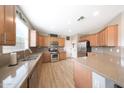 Well-equipped kitchen with stainless steel appliances, granite countertops, and ample cabinet space at 16039 W Pima St, Goodyear, AZ 85338