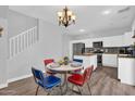 This charming dining area has a retro table and chairs, with a view of the modern kitchen at 16139 N 171St Ln, Surprise, AZ 85388