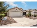 Single-story home with a two-car garage, xeriscaped front yard, and mature landscaping, perfect for low-maintenance living at 16424 S 46Th Way, Phoenix, AZ 85048
