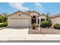 Inviting single-story home featuring a two-car garage, neutral paint, and xeriscaped front yard under a bright blue sky at 16424 S 46Th Way, Phoenix, AZ 85048
