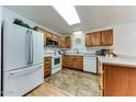 Functional kitchen featuring wood cabinets and bright lighting at 17200 W Bell Rd # 1015, Surprise, AZ 85374